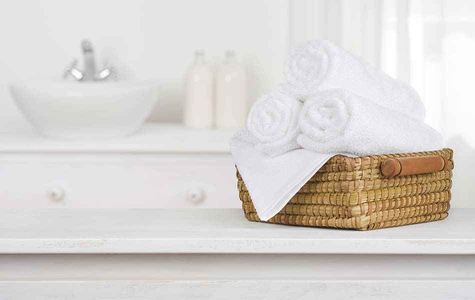 fresh white towels in clean white bathroom